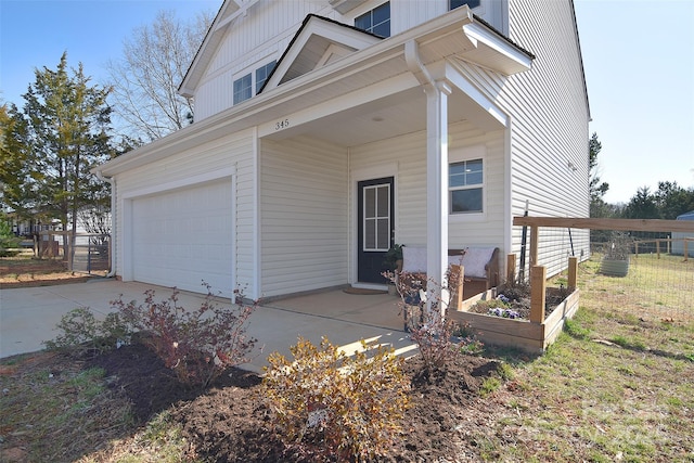 view of front facade featuring board and batten siding, driveway, and a garage