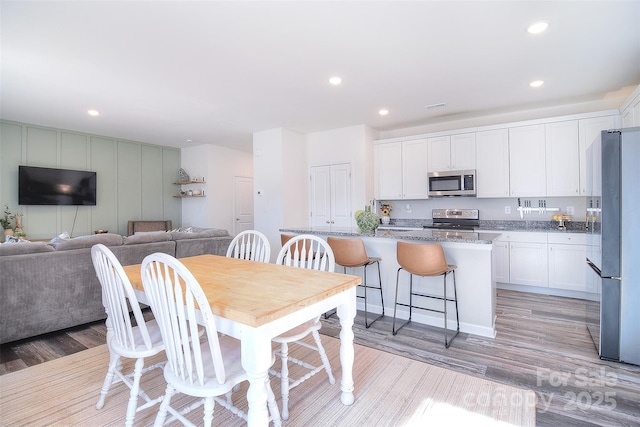 dining room featuring recessed lighting and light wood-style flooring