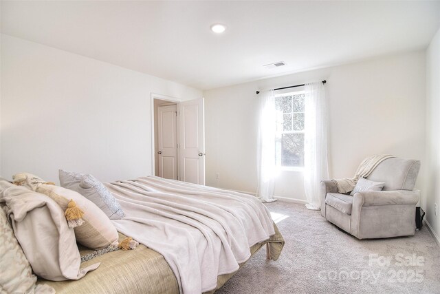 bedroom with baseboards, visible vents, and carpet floors