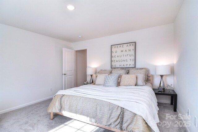 carpeted bedroom featuring baseboards