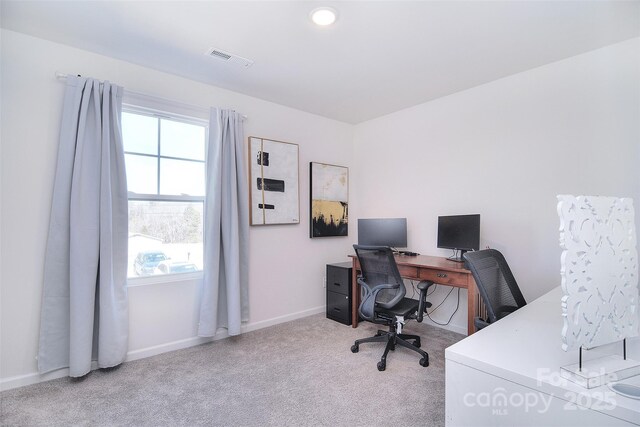 carpeted office featuring baseboards and visible vents