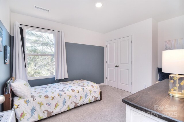 bedroom with visible vents and carpet floors