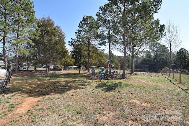 view of yard with a playground and fence