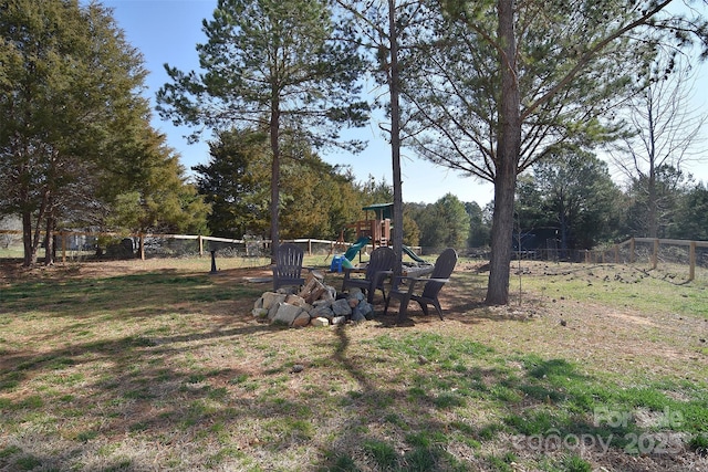 view of yard featuring fence and a playground