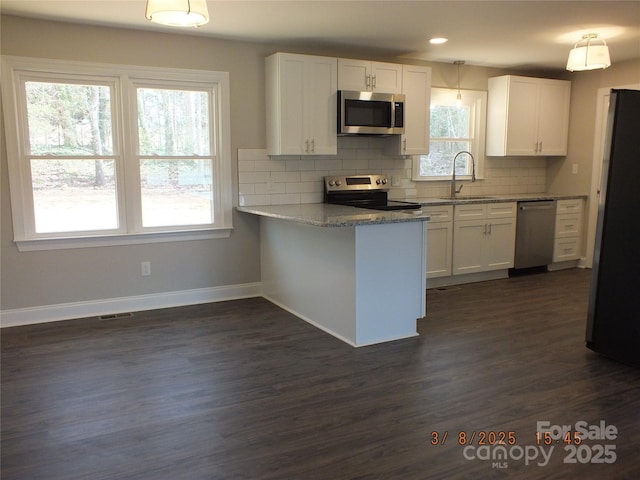 kitchen featuring stainless steel appliances, white cabinets, and a sink