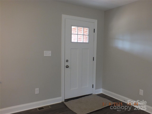 foyer with visible vents, dark wood finished floors, and baseboards