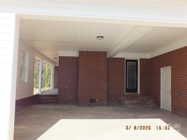 view of patio / terrace featuring entry steps and a carport