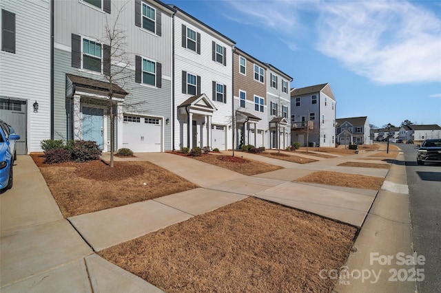 exterior space with an attached garage and a residential view