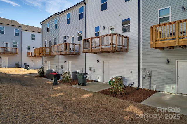 back of property featuring central AC unit