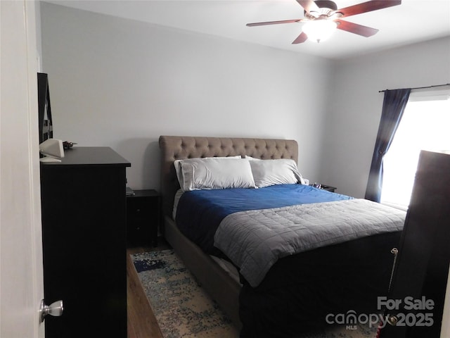 bedroom with a ceiling fan and wood finished floors