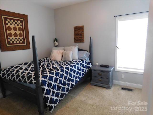 bedroom with baseboards, visible vents, and carpet floors