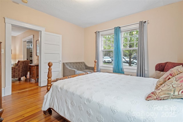 bedroom featuring wood finished floors and a textured ceiling