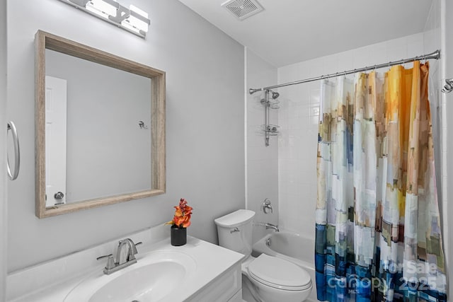 bathroom with vanity, shower / tub combo, toilet, and visible vents