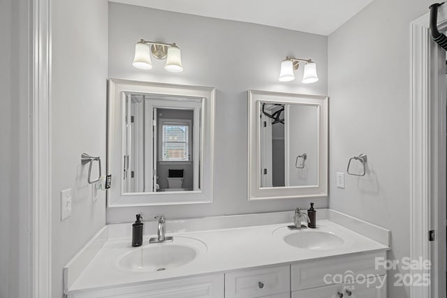 bathroom featuring a sink and double vanity