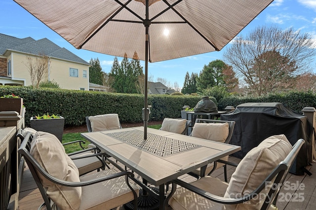 view of patio with outdoor dining space and fence