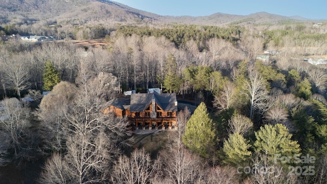 drone / aerial view with a mountain view and a wooded view