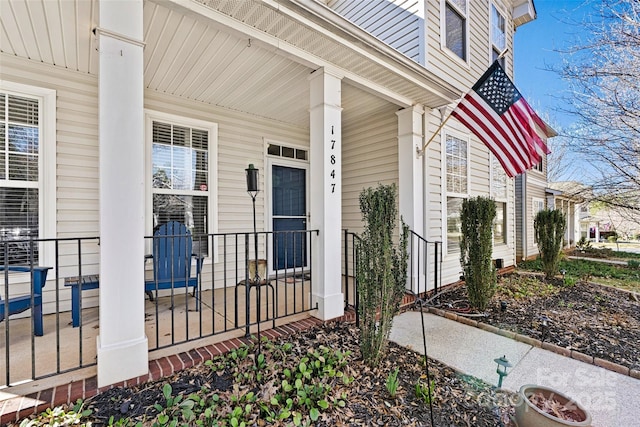 view of exterior entry with a porch