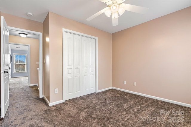 unfurnished bedroom with a closet, baseboards, and carpet floors