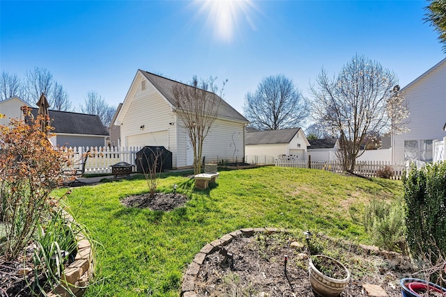 view of yard featuring an outbuilding, a garage, and fence