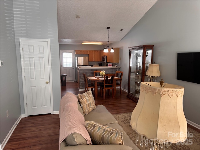 living area featuring baseboards, vaulted ceiling, and wood finished floors