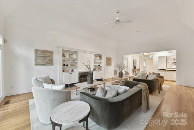 2411 Calais Pl, Charlotte, NC 28211 - living area featuring light wood finished floors, a ceiling fan, and baseboards