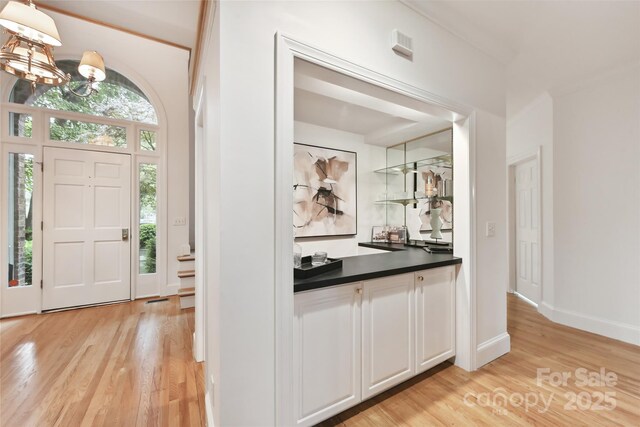 2411 Calais Pl, Charlotte, NC 28211 - entrance foyer with light wood finished floors, a chandelier, and baseboards