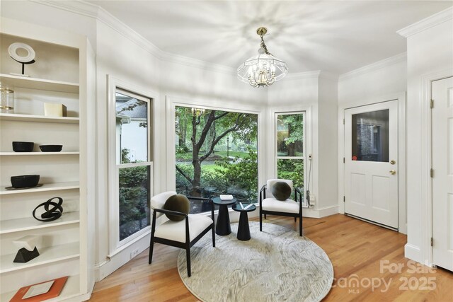2411 Calais Pl, Charlotte, NC 28211 - sitting room with light wood-style flooring, a chandelier, ornamental molding, and built in features