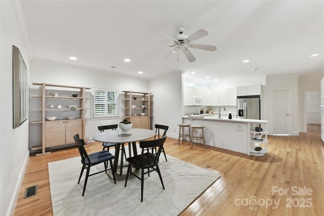 2411 Calais Pl, Charlotte, NC 28211 - dining space with baseboards, a ceiling fan, light wood-type flooring, recessed lighting, and ornamental molding