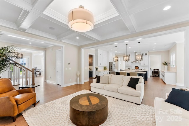 living room with light wood-type flooring, coffered ceiling, and beamed ceiling