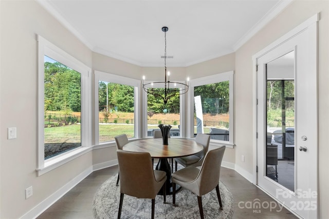 dining room with baseboards, dark wood-type flooring, an inviting chandelier, and crown molding