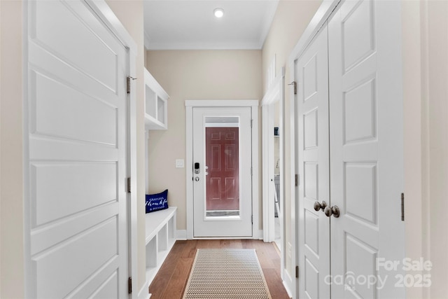 mudroom featuring baseboards, dark wood-style flooring, and crown molding