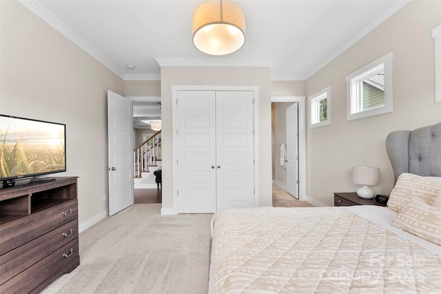 bedroom with baseboards, ornamental molding, a closet, and light colored carpet