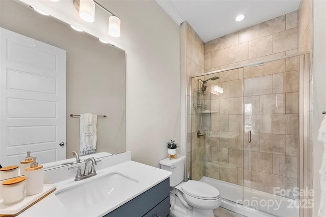 full bathroom with a stall shower, vanity, and toilet