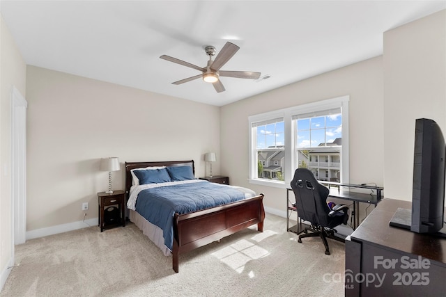 bedroom featuring baseboards, visible vents, a ceiling fan, and light colored carpet