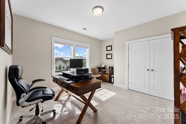 home office featuring light carpet, visible vents, and baseboards