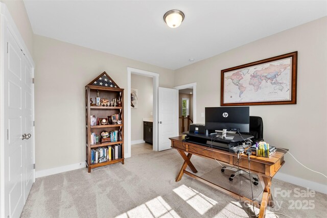 office area with light colored carpet and baseboards