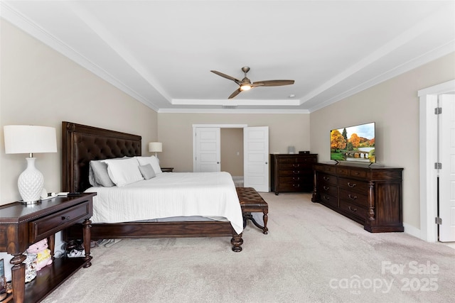 bedroom featuring a ceiling fan, a raised ceiling, and light colored carpet