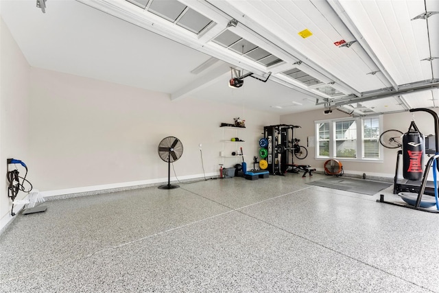 garage with baseboards and a garage door opener