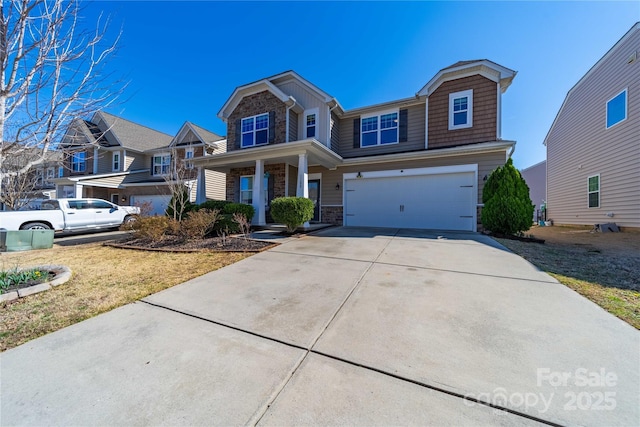 view of front facade with a garage, stone siding, and driveway