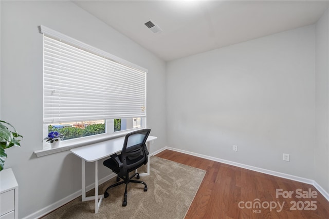 office space with visible vents, baseboards, and wood finished floors