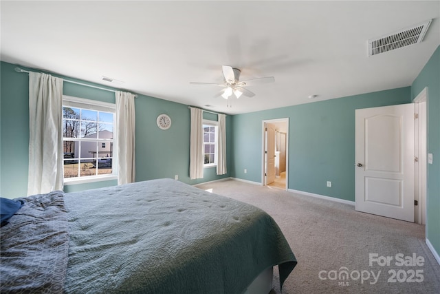 carpeted bedroom with visible vents, multiple windows, and baseboards