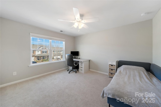 bedroom with visible vents, baseboards, light colored carpet, and ceiling fan