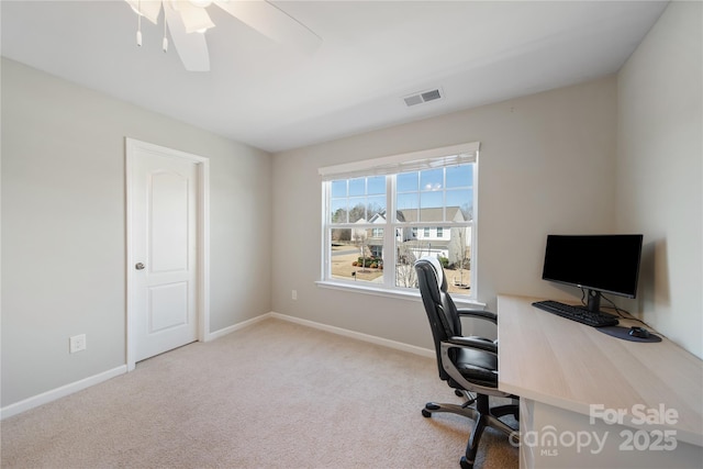 carpeted office with visible vents, ceiling fan, and baseboards