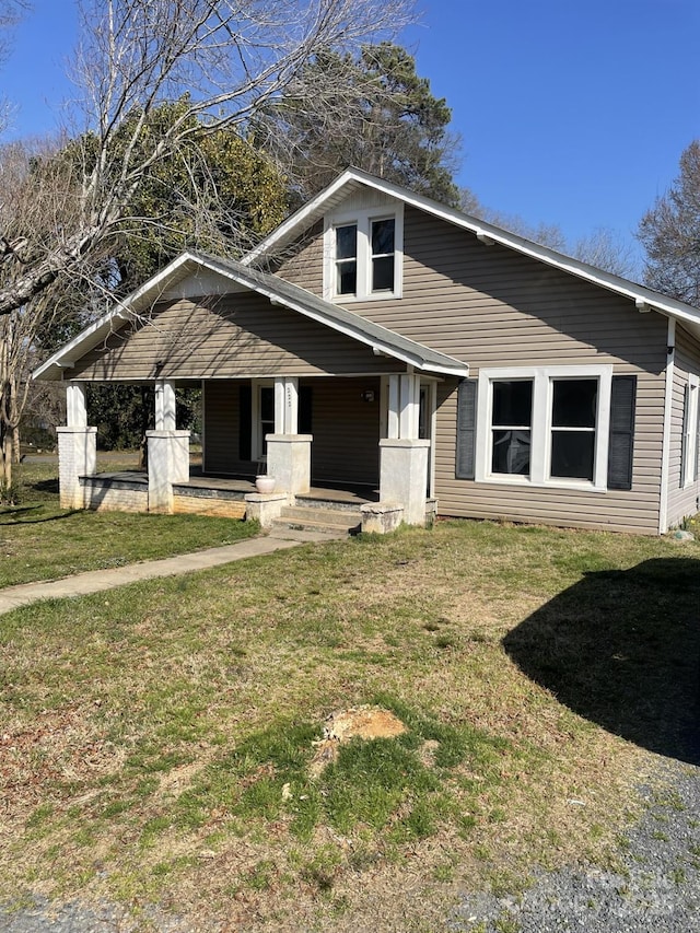 view of front of house with a porch and a front yard