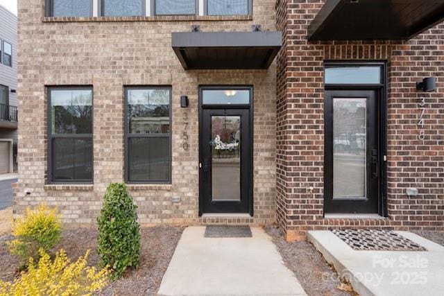 entrance to property with brick siding