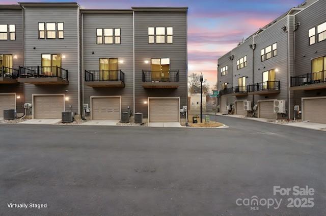 exterior space featuring a garage and central AC