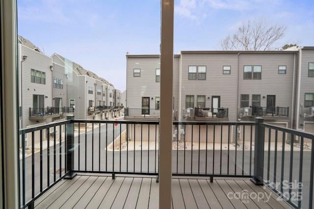 wooden deck with a residential view