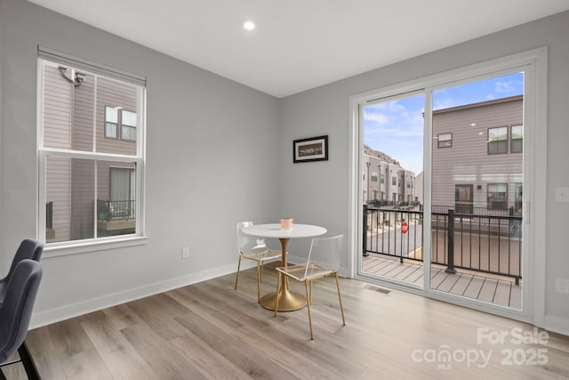 dining area featuring baseboards, visible vents, wood finished floors, and recessed lighting