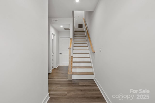 stairs with recessed lighting, visible vents, baseboards, and wood finished floors