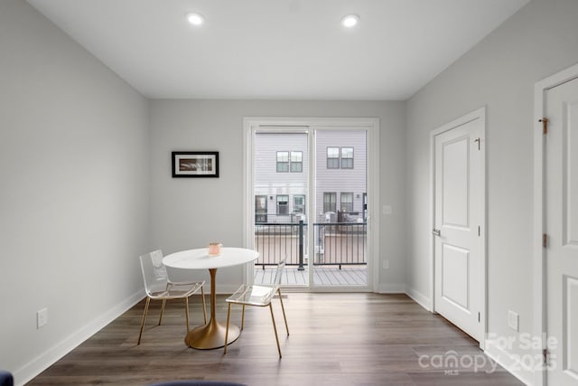 dining space featuring baseboards, wood finished floors, and recessed lighting